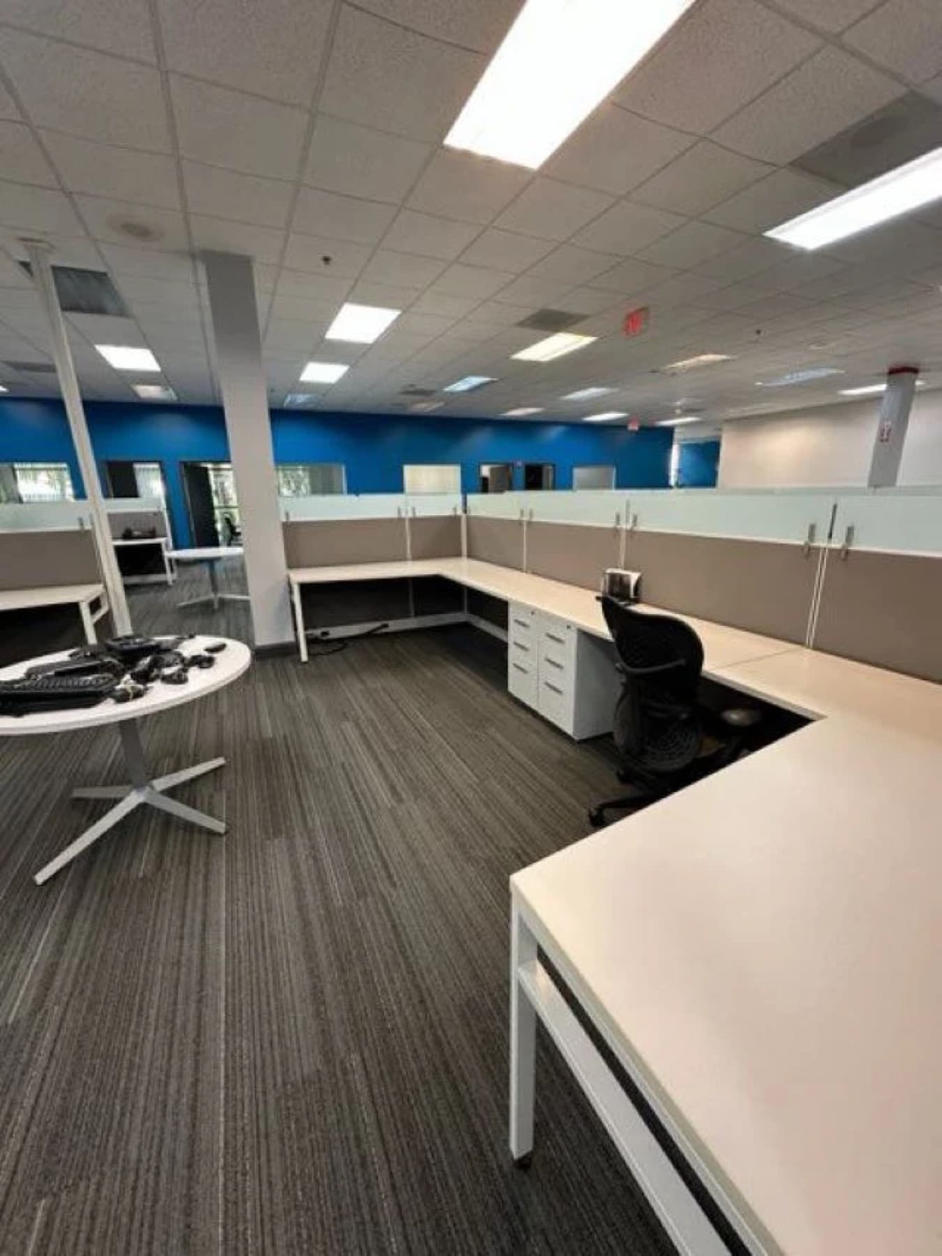 Open-plan office workstations vacuumed and reset on a nightly janitorial visit