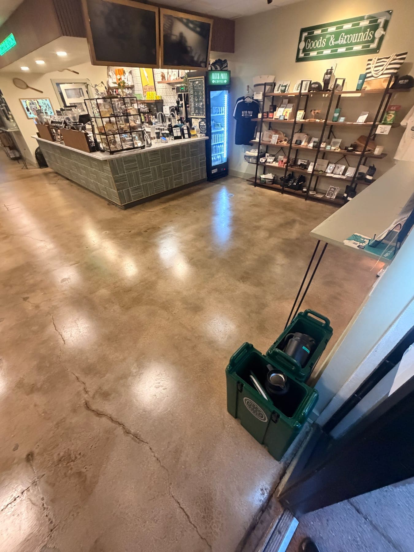The same cafe sales floor after cleaning and polishing, reflecting the ceiling lights